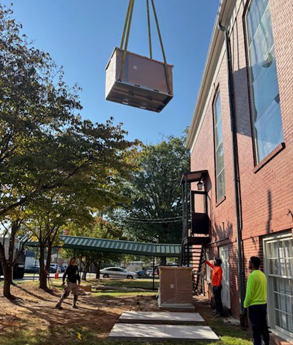 crane-lifting-AC-unit-to-the-roof-of-the-church-in-Brookhave-GA