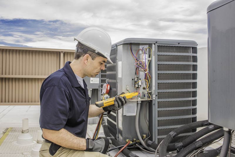 hvac-technician-repairing-ac-unit